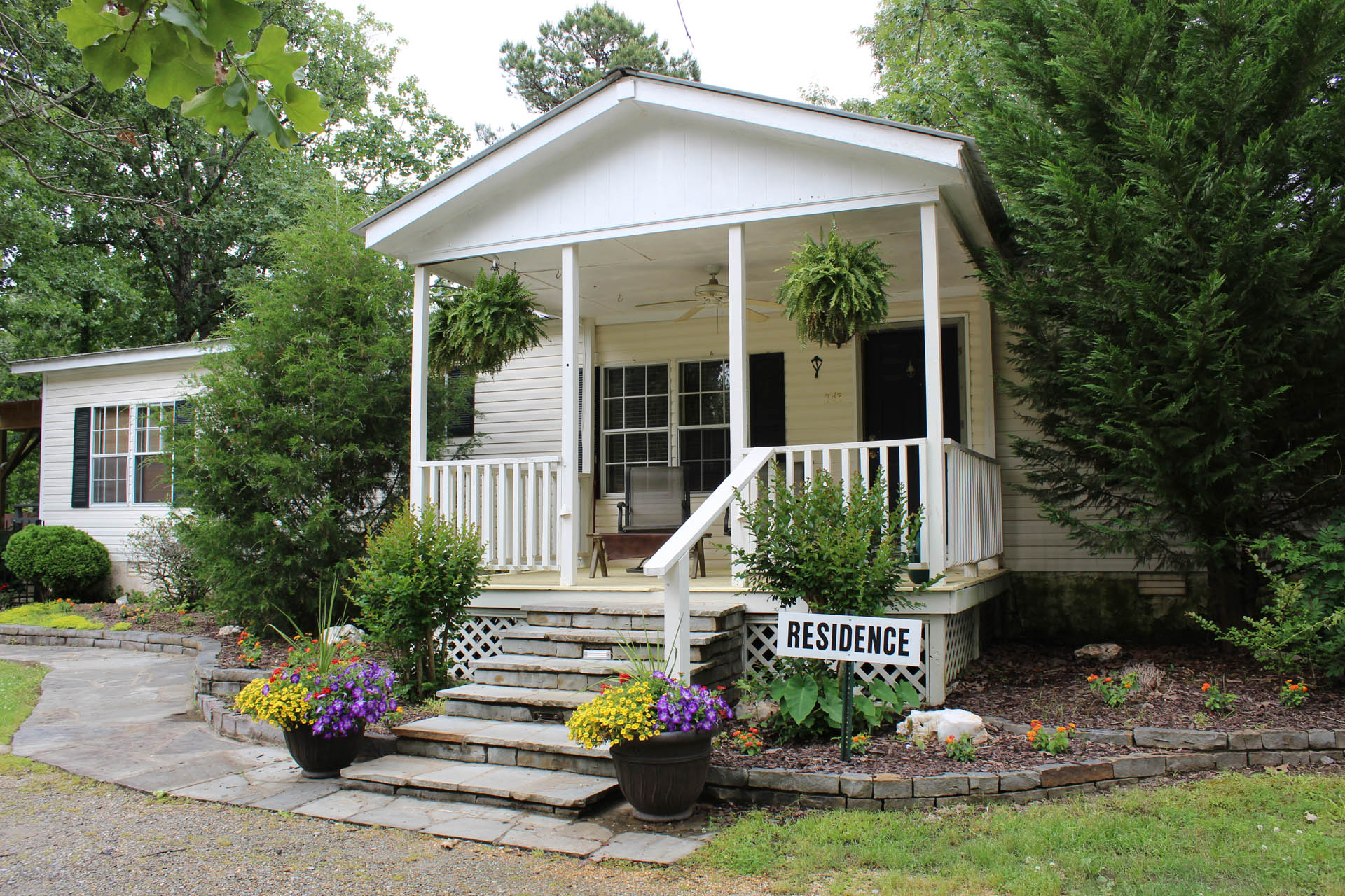 Residential recovery cottage with front porch and landscaped entry