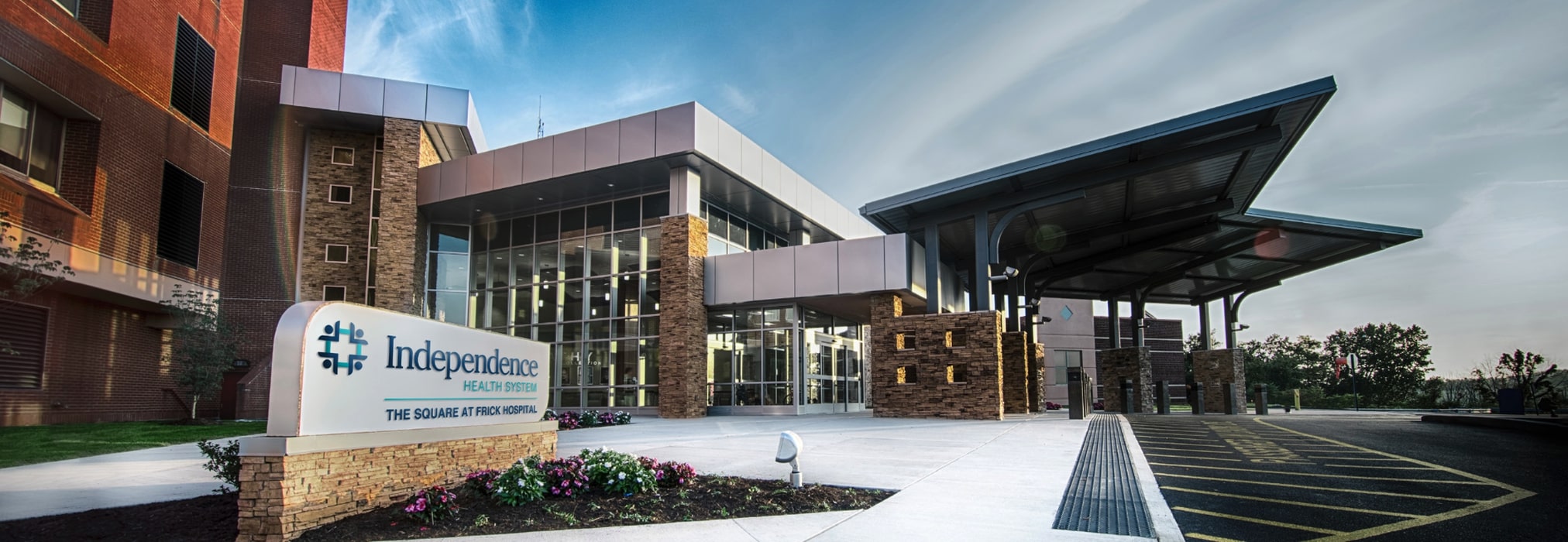 Main entrance of Frick Hospital with sign and glass exterior