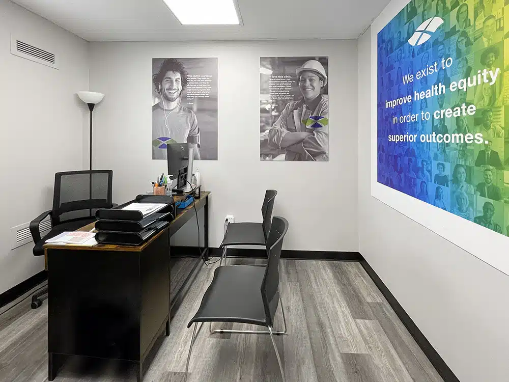 Office with desk, chairs, and health equity wall sign
