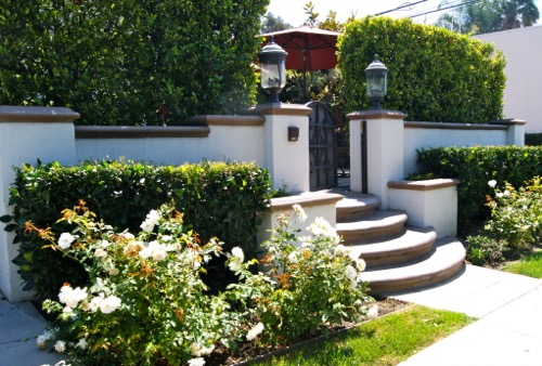 Garden entry with steps leading to gated entrance