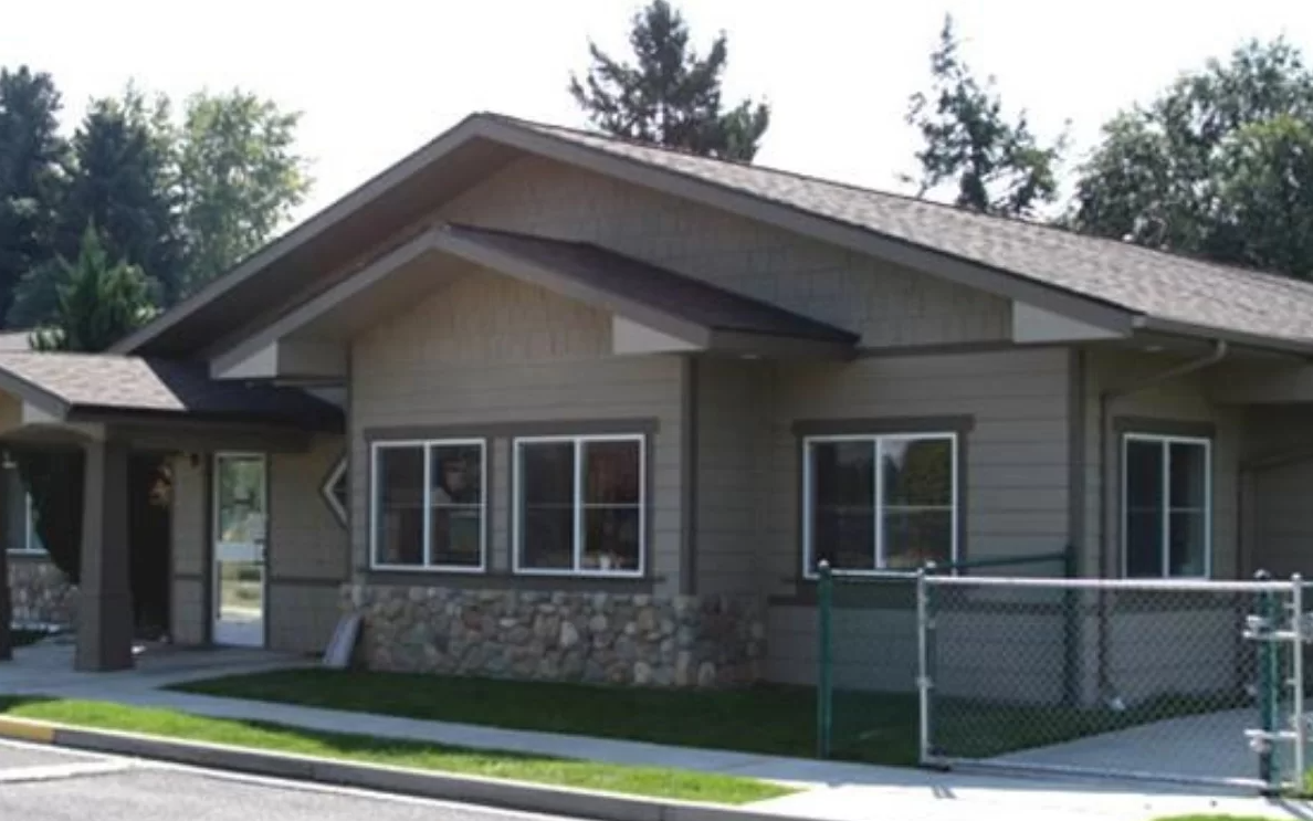 Single-story rehab facility exterior with stone and siding