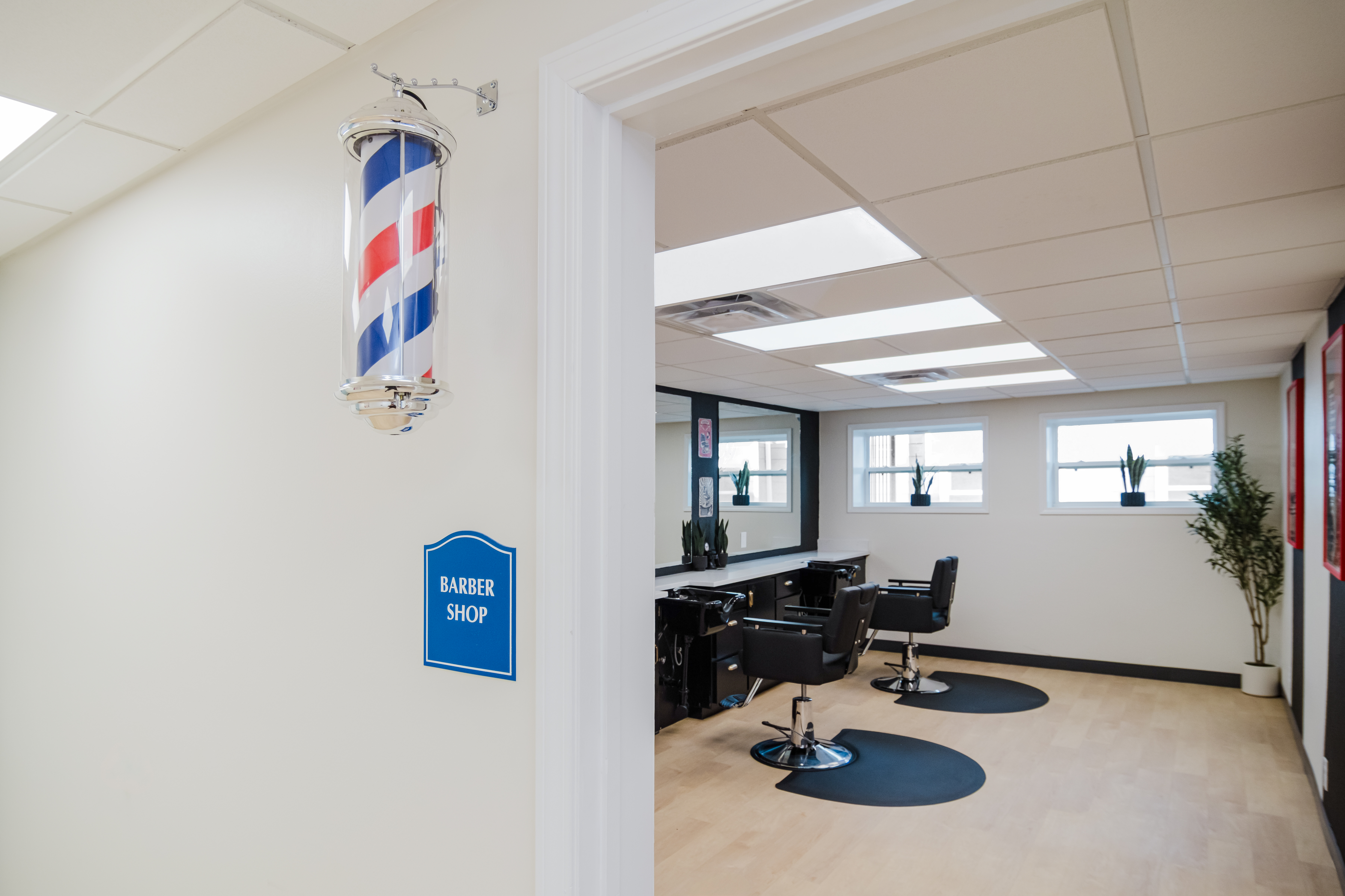 On-site barber shop with styling chairs and mirrors.