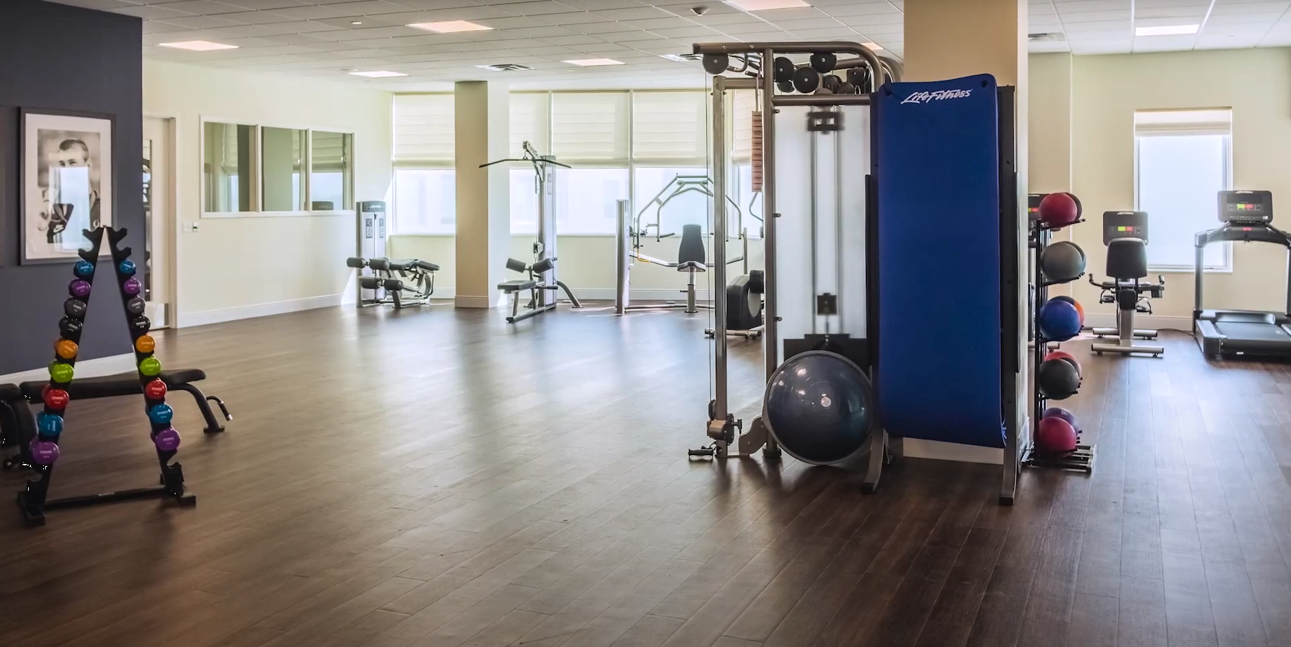 On-site fitness room with exercise machines and weights