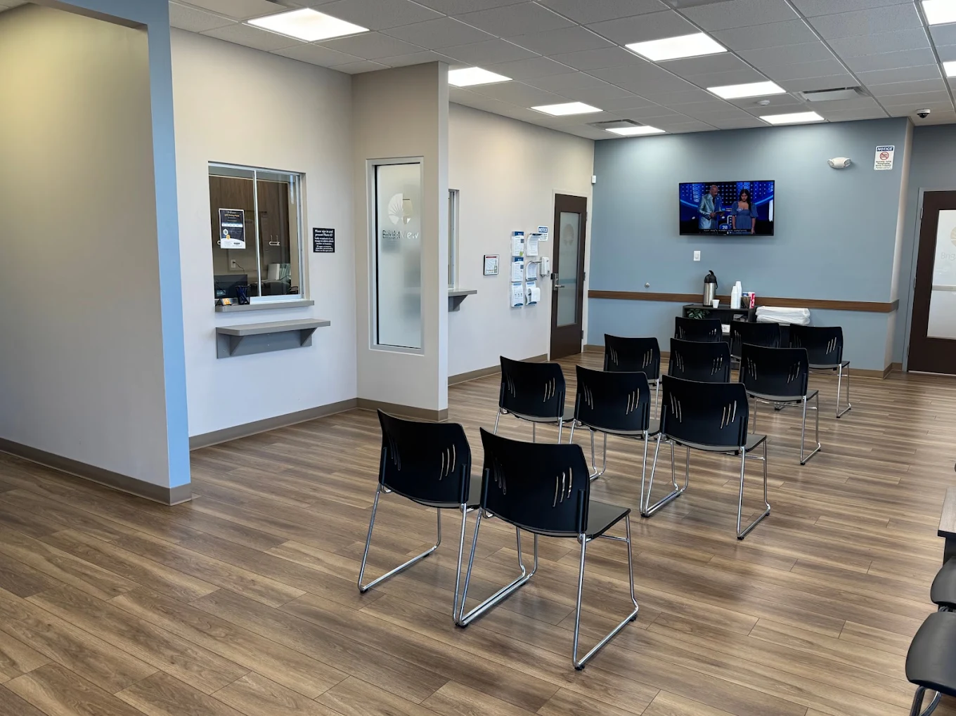 BrightView Glasgow lobby with patient seating, reception windows, and wall-mounted TV