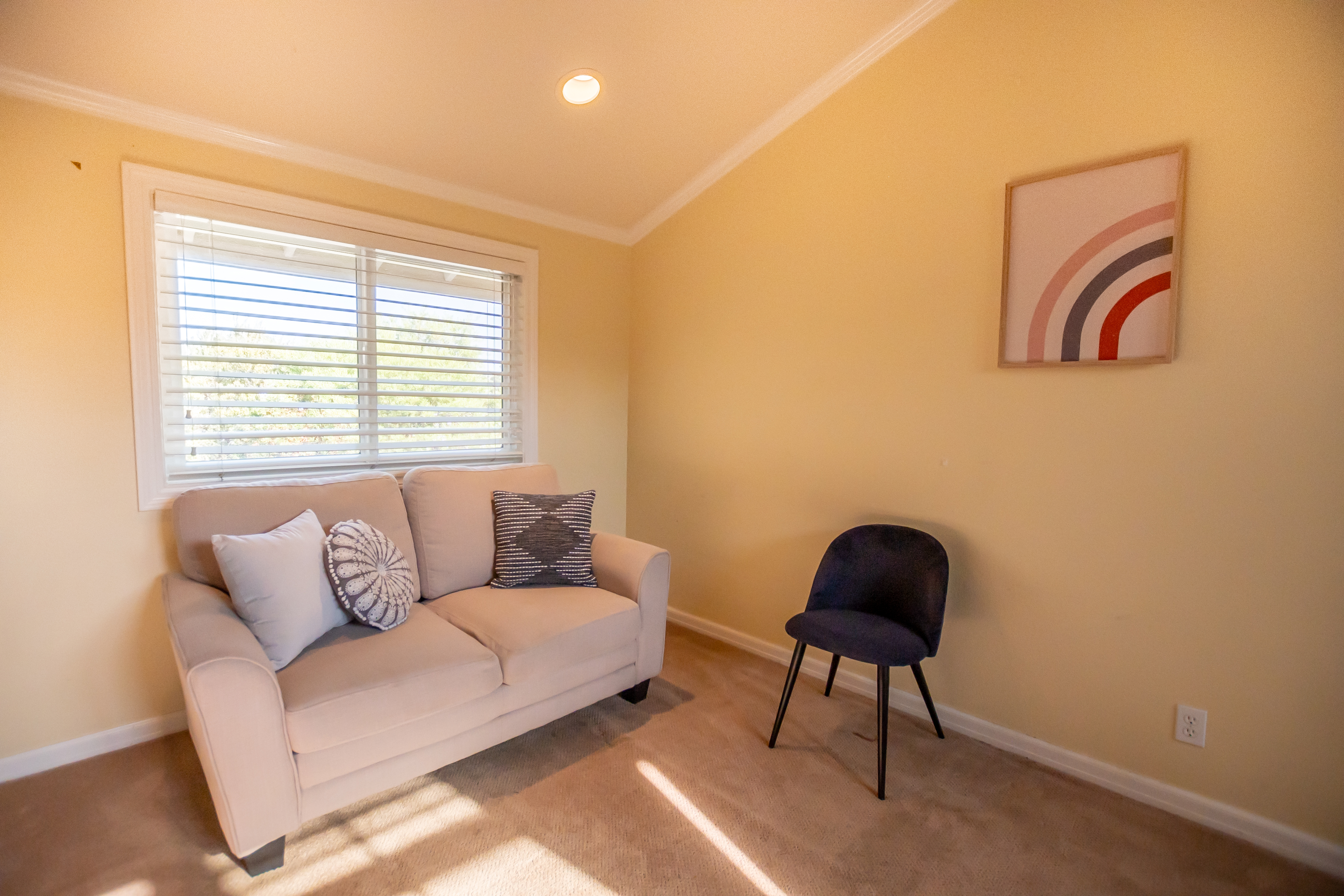 Small therapy room with sofa and chair