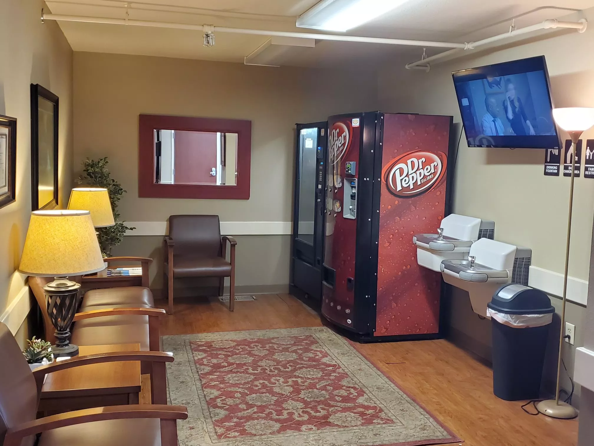 Lobby with seating, vending machines, TV, and water fountains