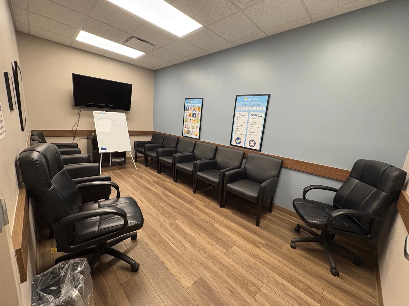 Group counseling room with chairs, TV, and presentation board