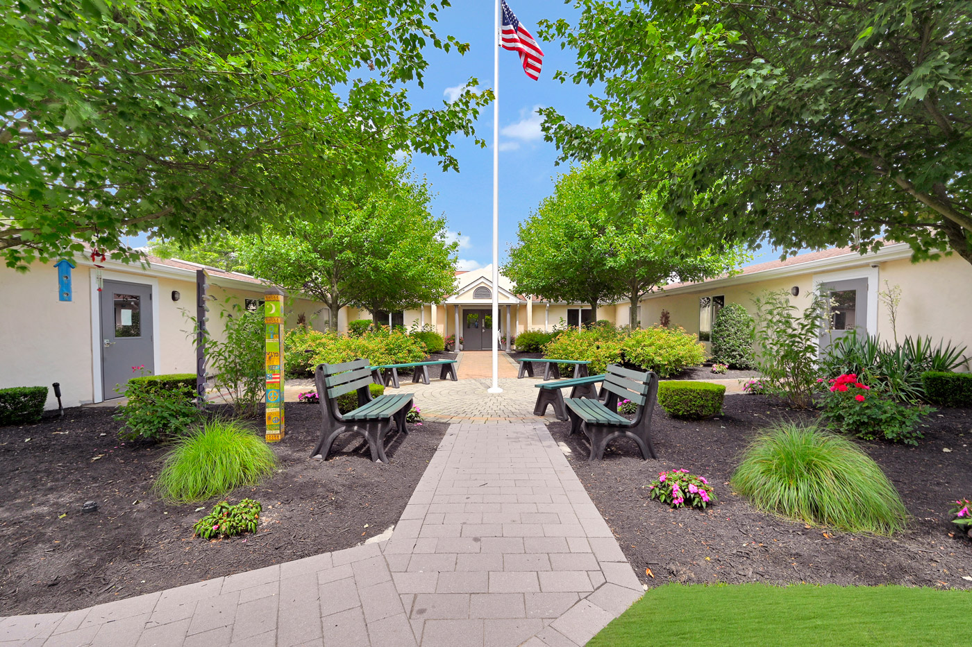Courtyard with benches, landscaping, and central flagpole