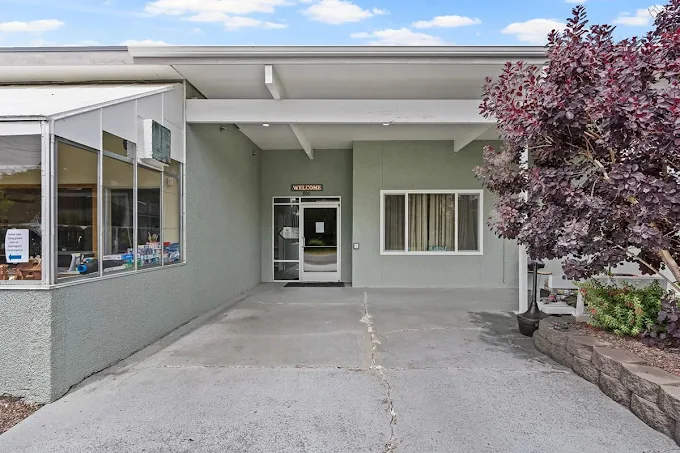 Front entrance with covered walkway and glass door
