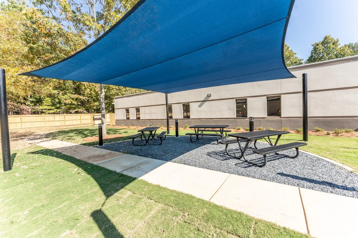 Shaded outdoor patio with picnic tables