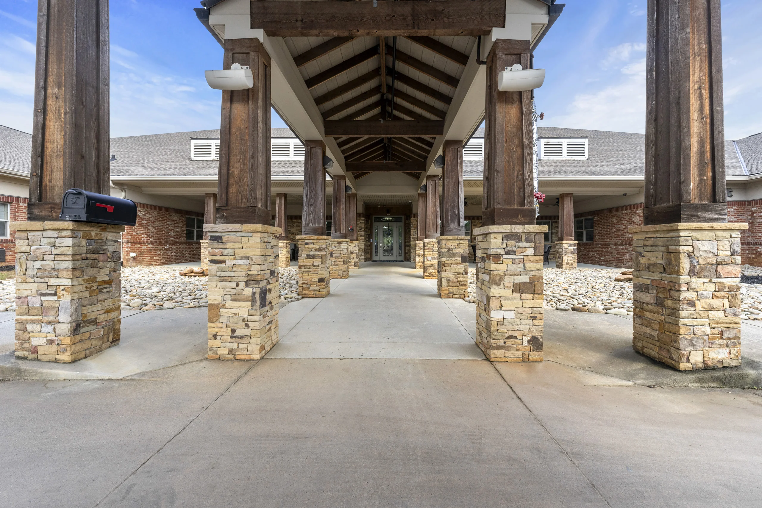Covered drop-off entrance with stone columns leading to the main entrance at Promises Atlanta