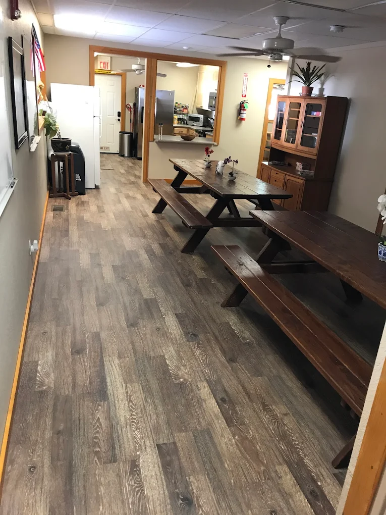 Shared dining room with long tables and seating