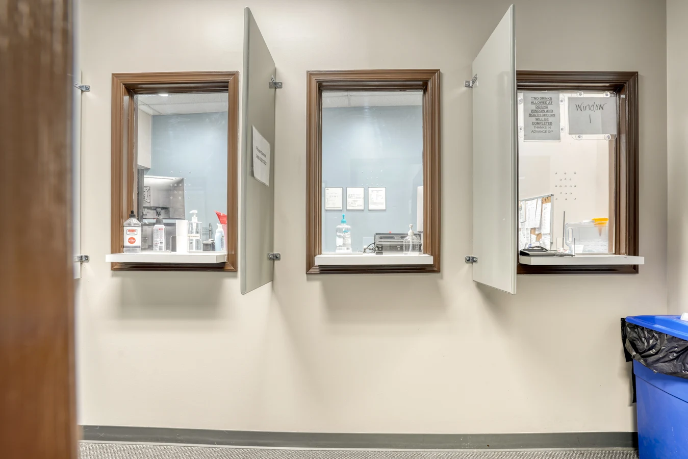 Three medication dispensing windows with privacy panels