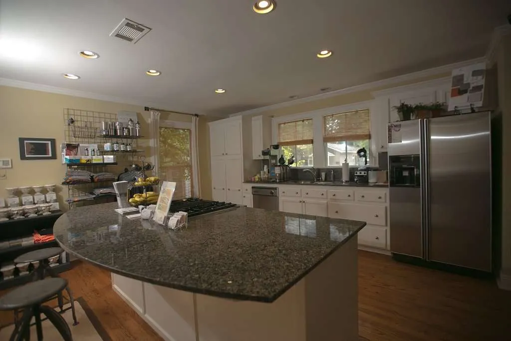 Open kitchen with granite island and stainless fridge