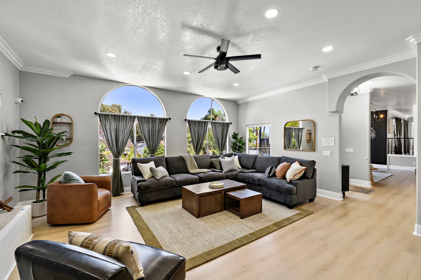 Living area with sectional sofa and large arched windows