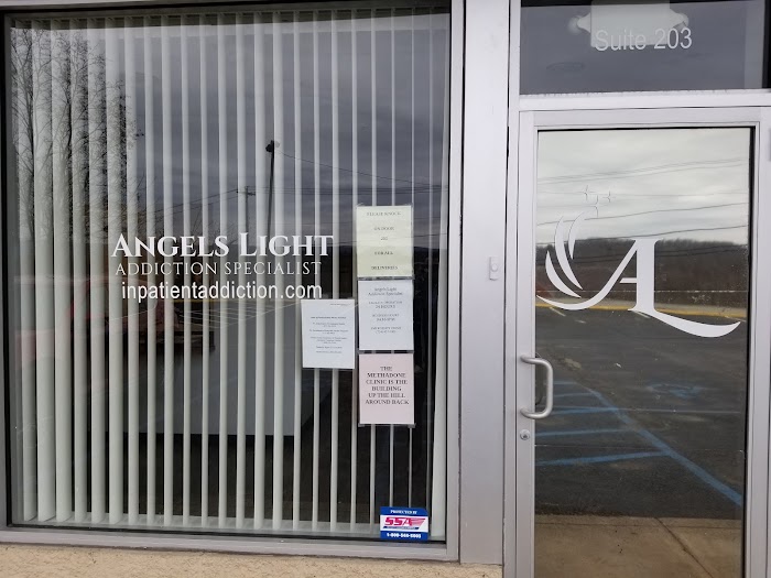 Facility entrance with logo and posted signs on glass