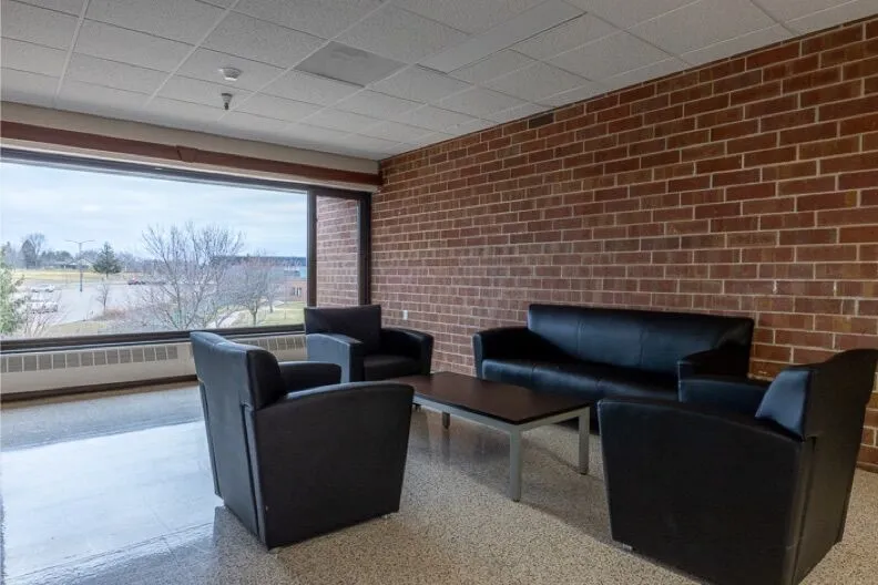 Indoor seating area with couches and table near large window