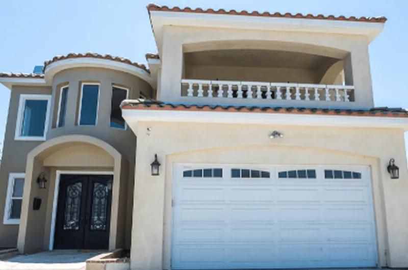Facility exterior with a balcony, garage and entrance.