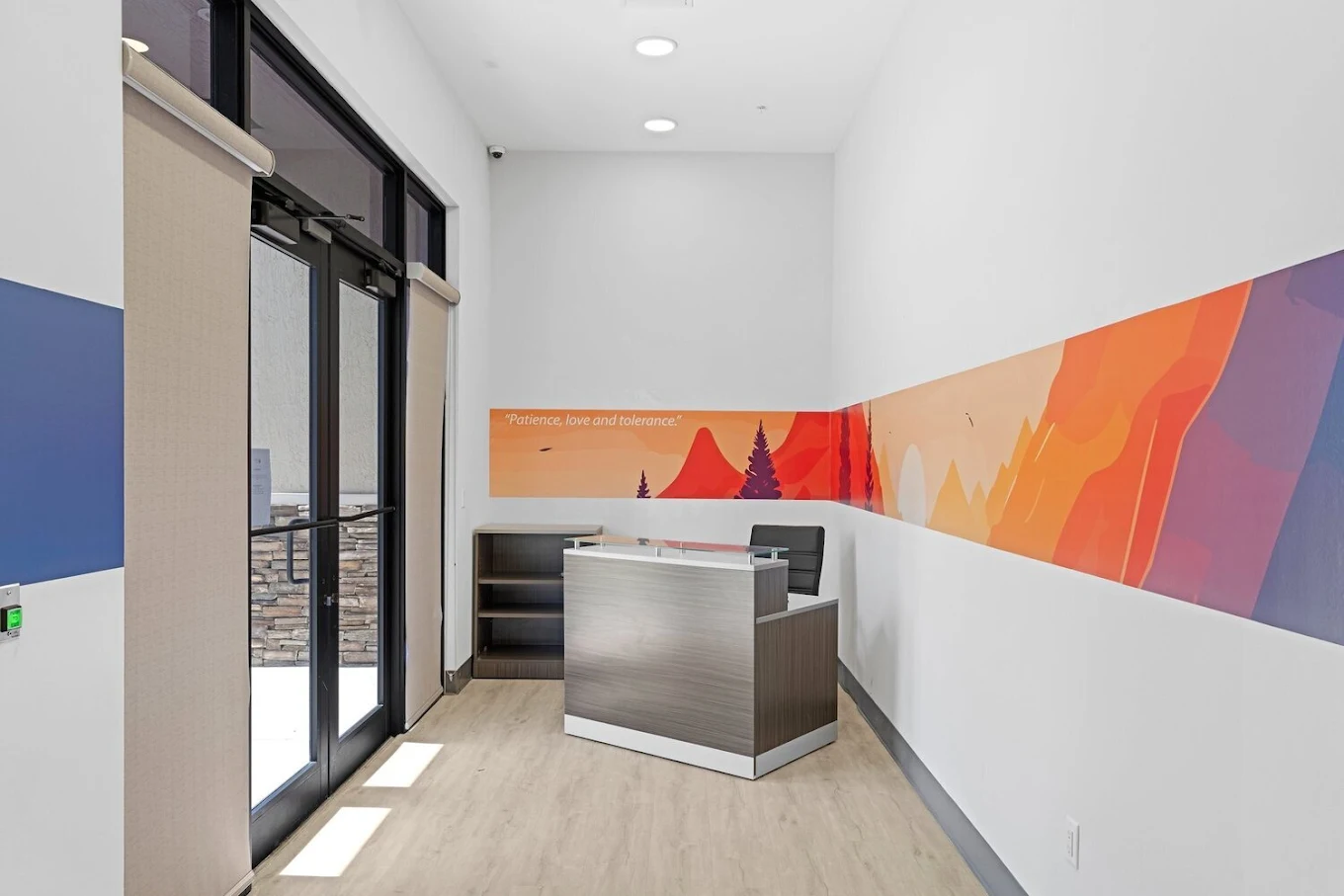Modern reception desk with colorful wall mural