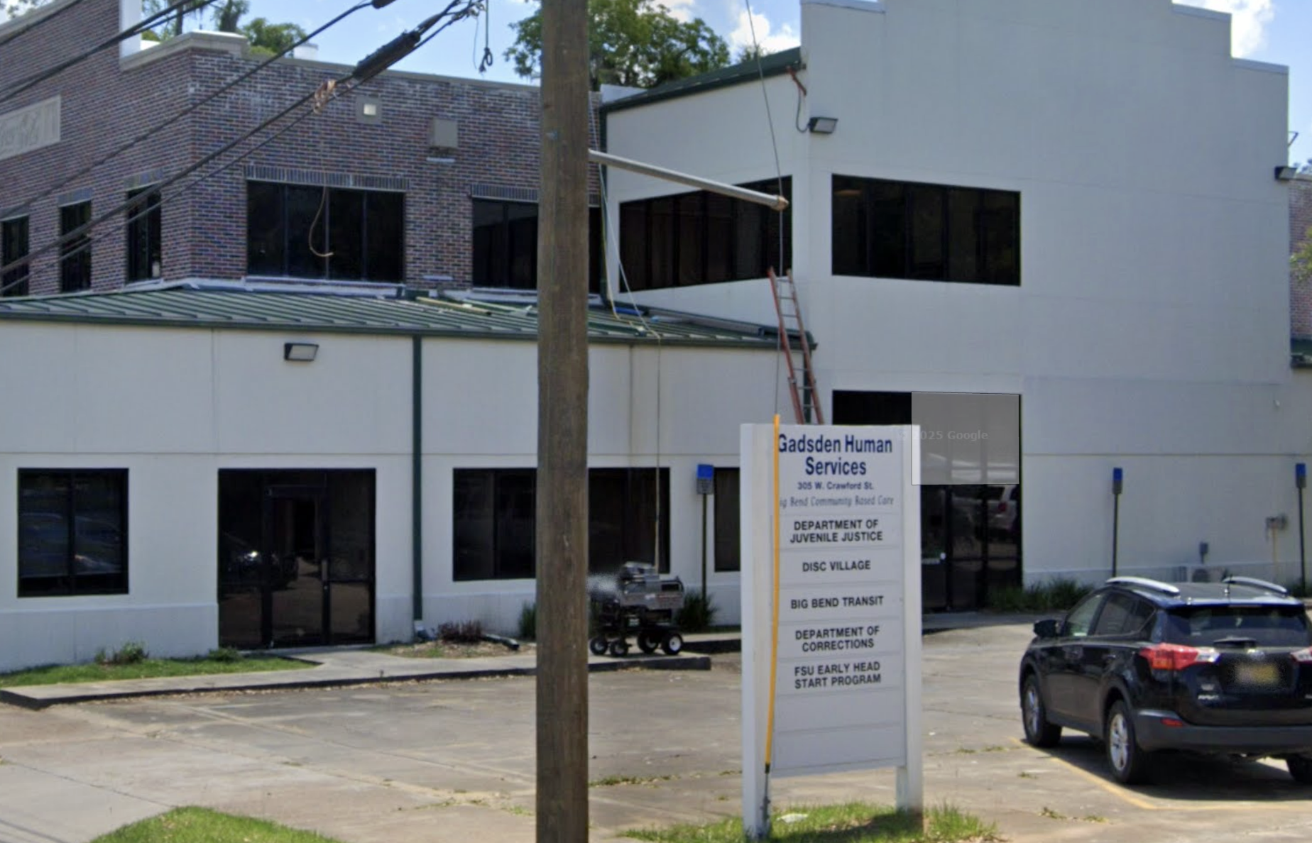Facility sign in parking lot outside Gadsden Human Services building