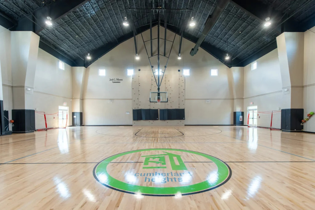 Large basketball court with rock wall and polished floor