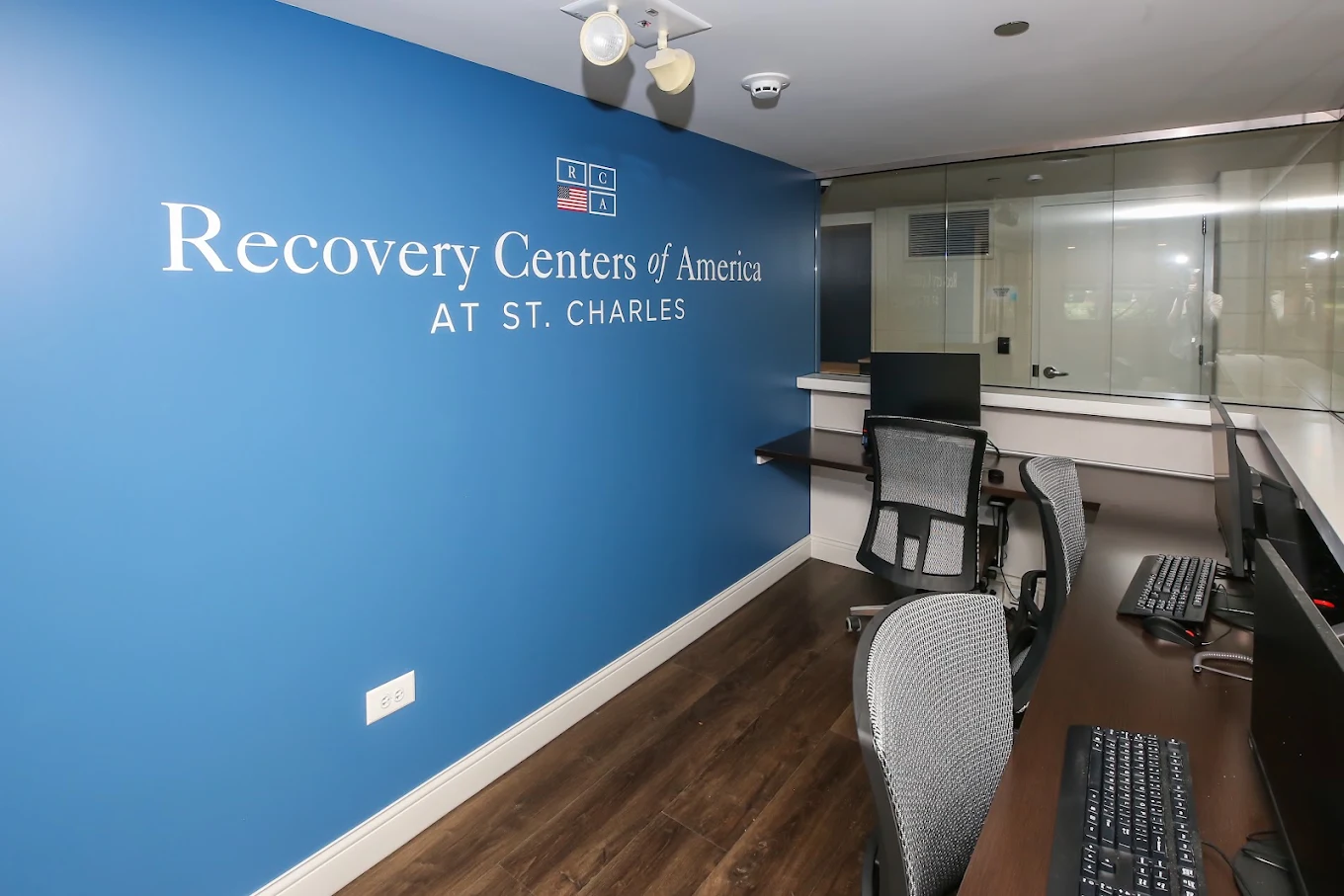 Reception area with RCA St. Charles logo on blue accent wall