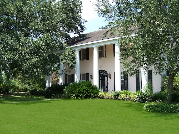 Grand entrance with columns and black shutters