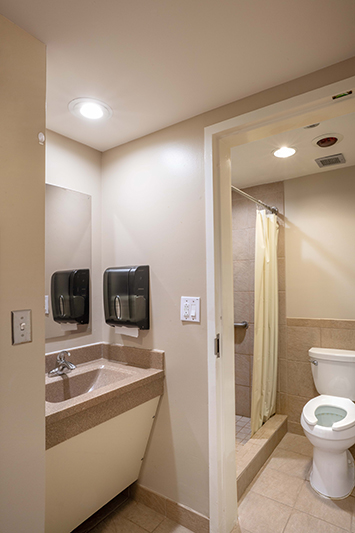 Clean bathroom with sink, toilet, and shower