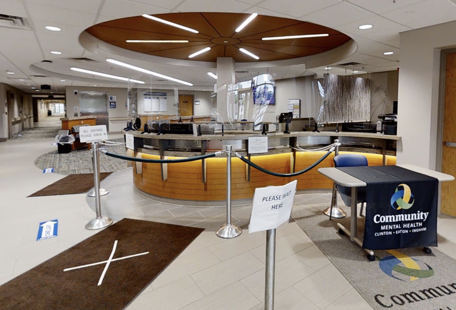 Modern lobby with curved reception desk and overhead lighting