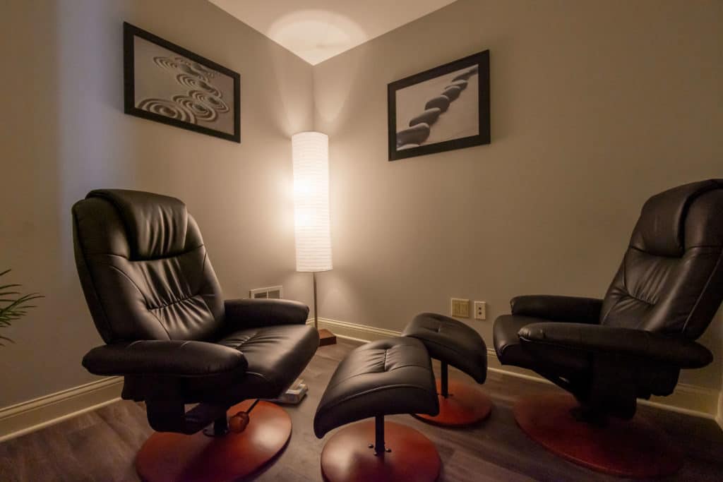 Therapy room with reclining chairs and soft lighting.