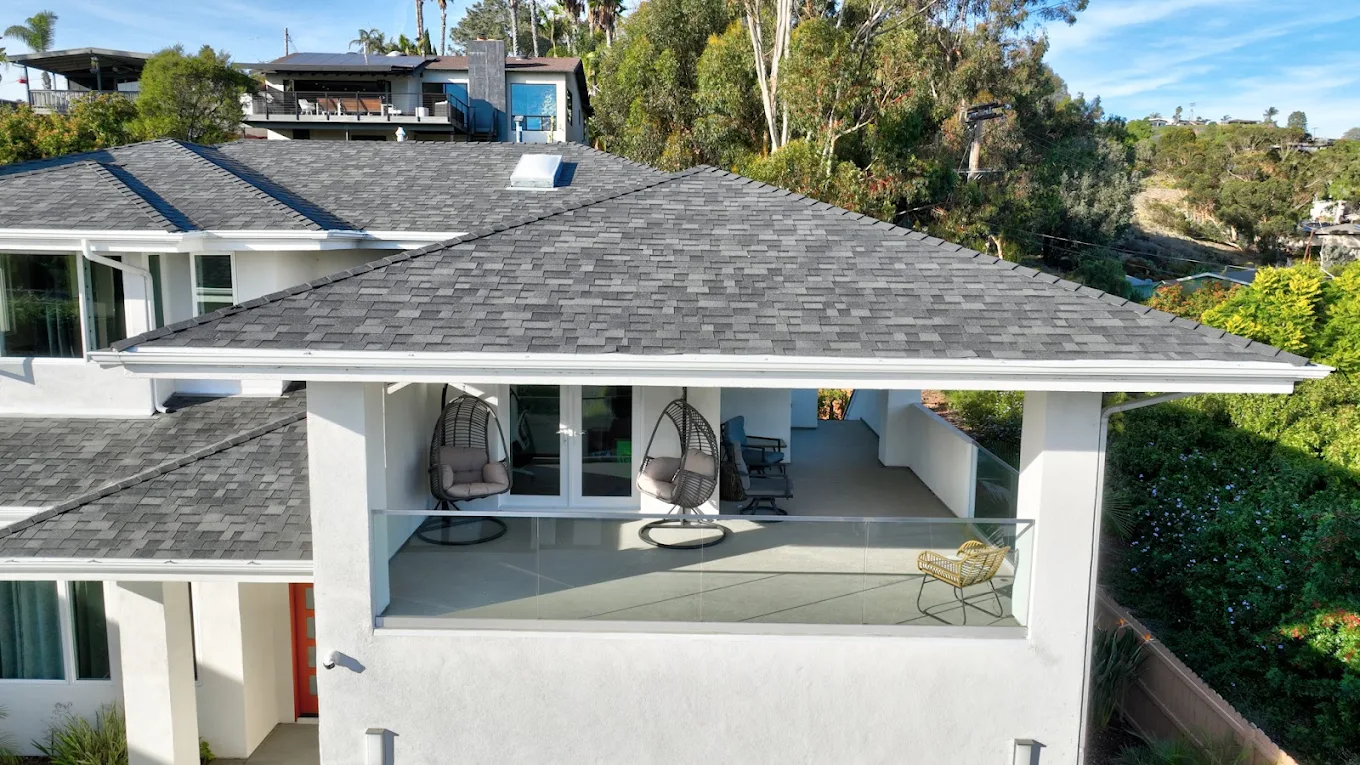 Outdoor veranda with hanging chairs and hillside view
