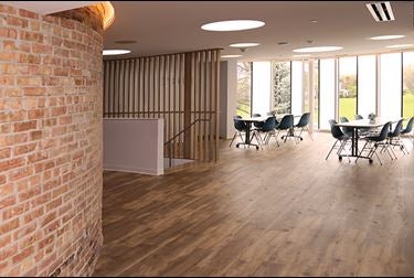 Large open room with tables and floor-to-ceiling windows