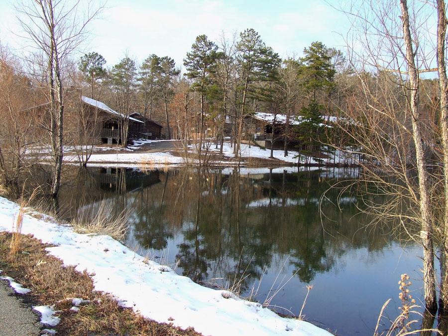 Cabins near a lake with snow on the ground