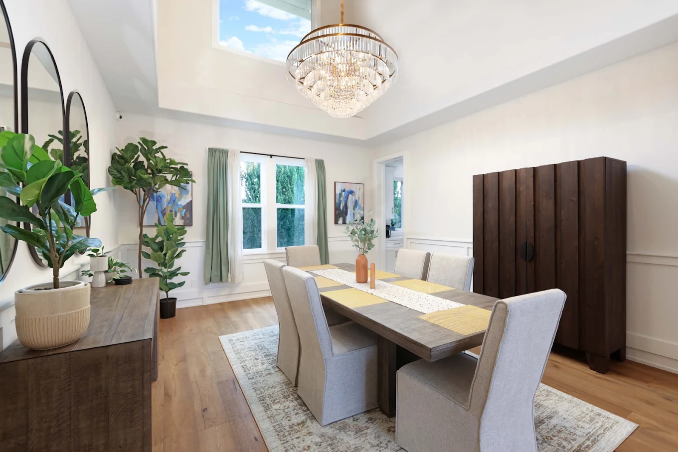 Dining room with table, upholstered chairs, and chandelier