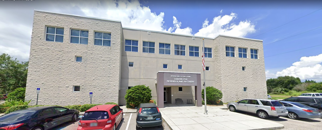 Rehab facility exterior with front awning and flagpole