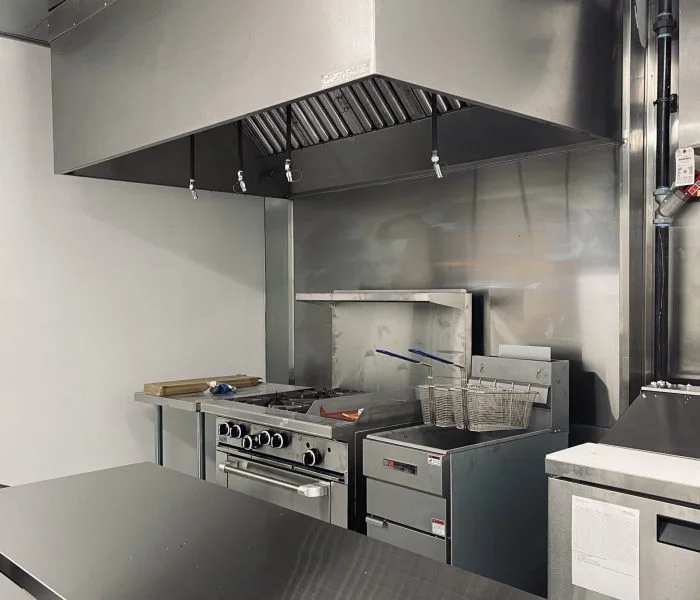 Commercial kitchen with stove, fryer, and counters
