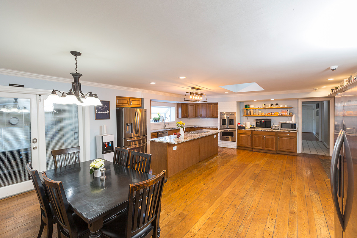 Spacious kitchen with island and stainless appliances