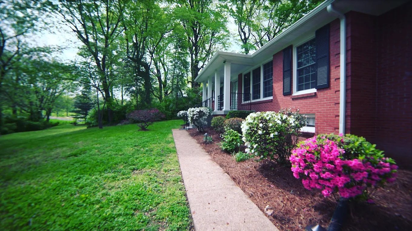 Red brick facility with landscaped flowers