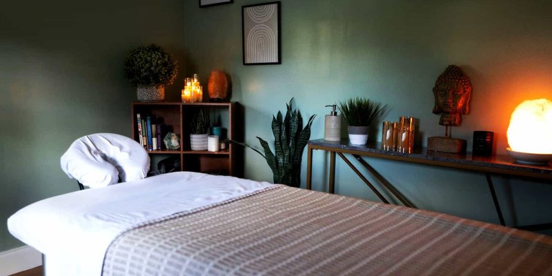 Tranquil massage room with soft lighting and decor.