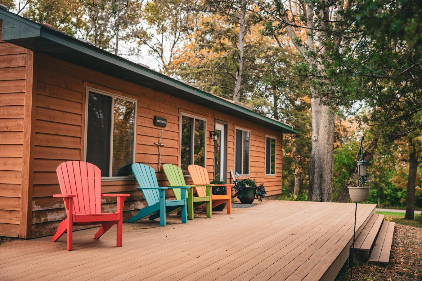 Wooden cabin deck with colorful outdoor seating