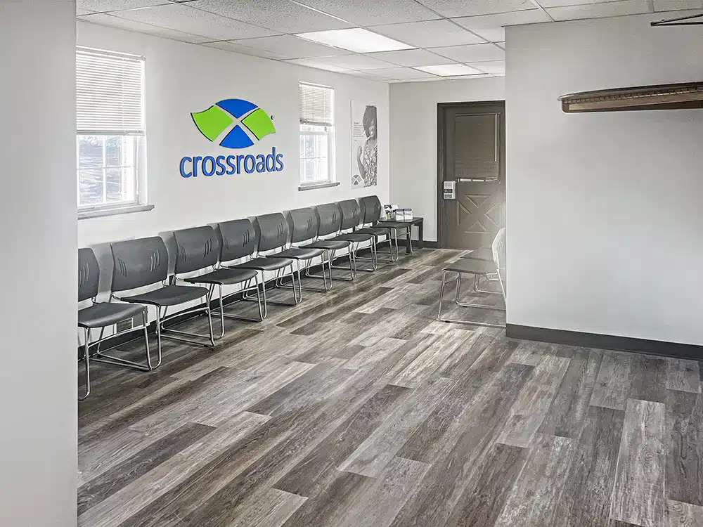 Waiting room with chairs lined along wall and logo display