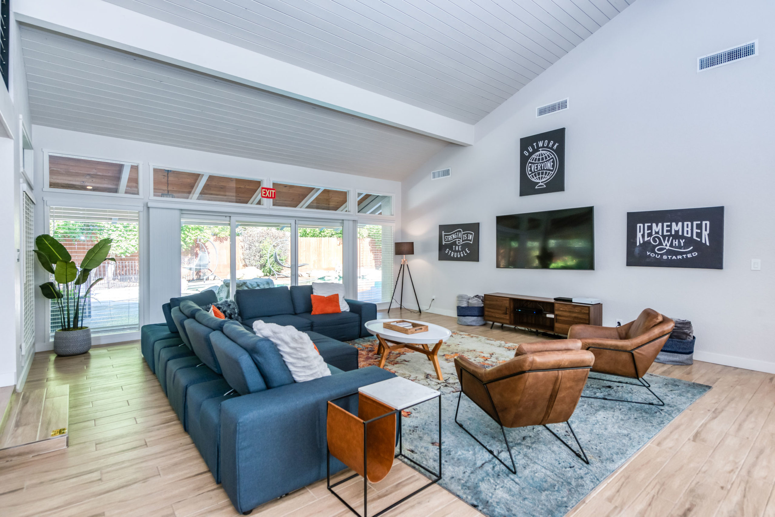 Cozy lounge with sectional, chairs, and TV