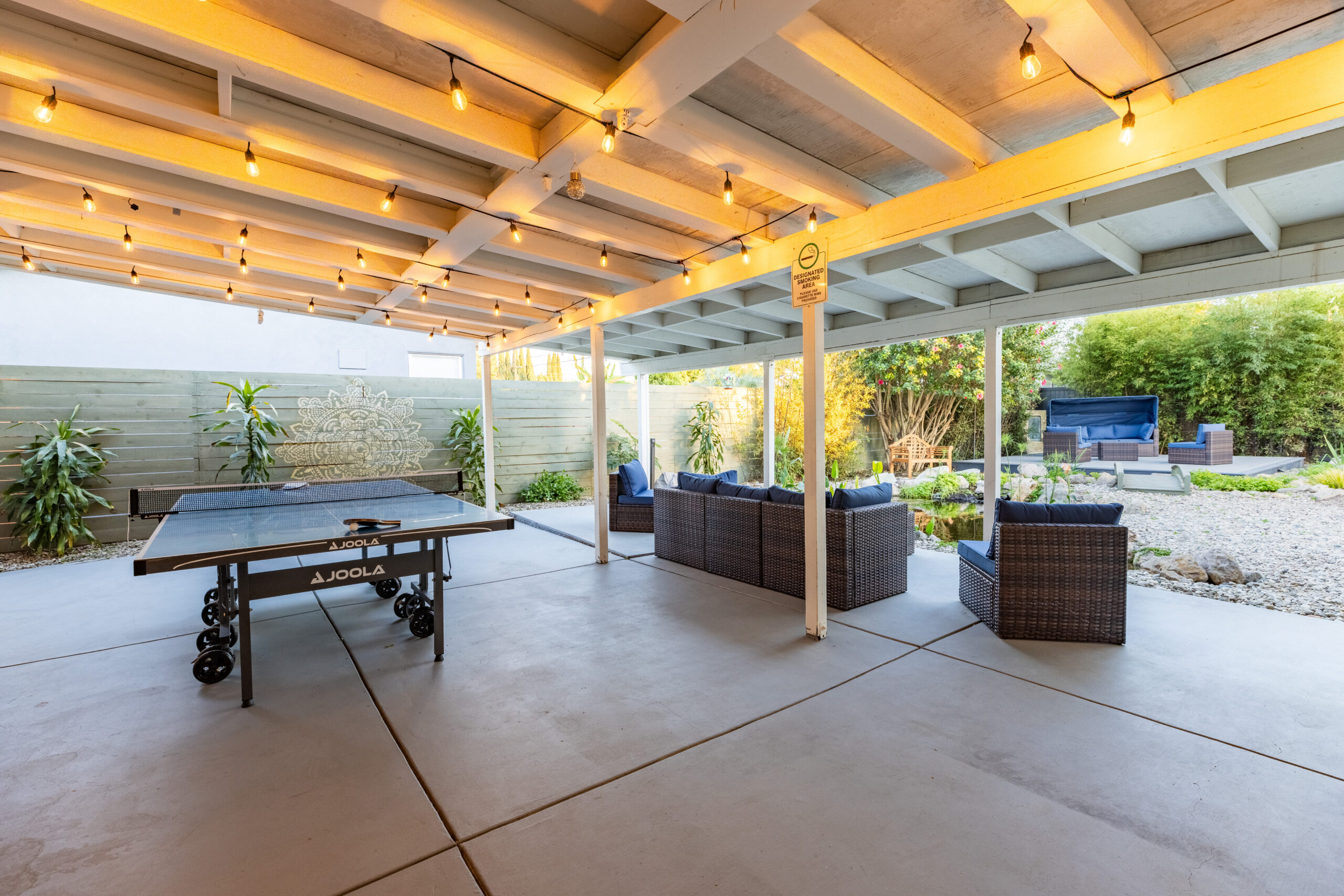 Ping pong table and lounge area under a covered patio