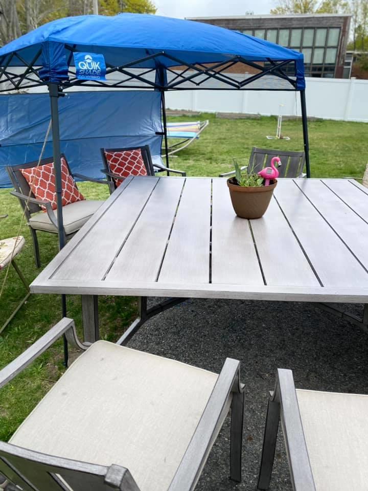 Patio table with chairs under blue canopy