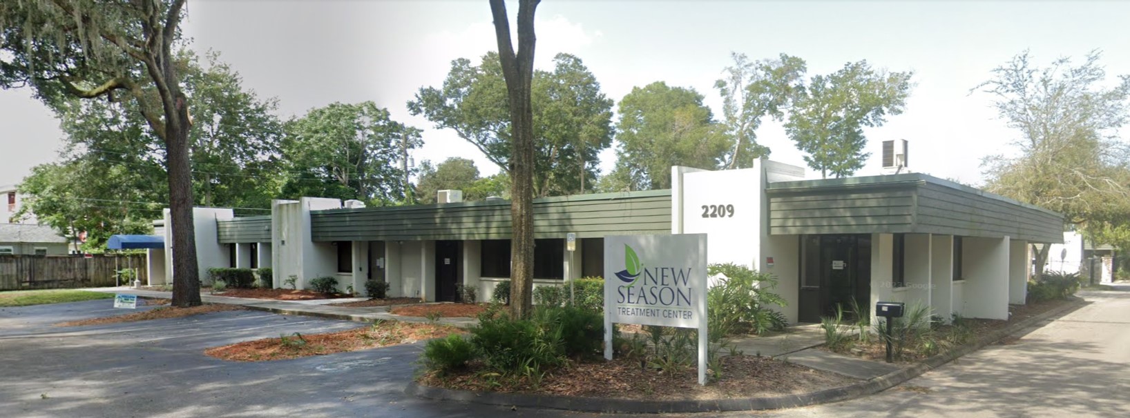 Facility exterior with signage and parking.