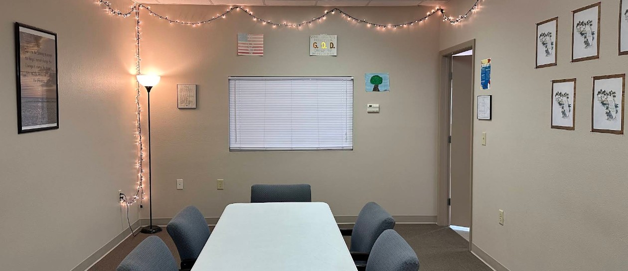 Group therapy room with meeting table and chairs