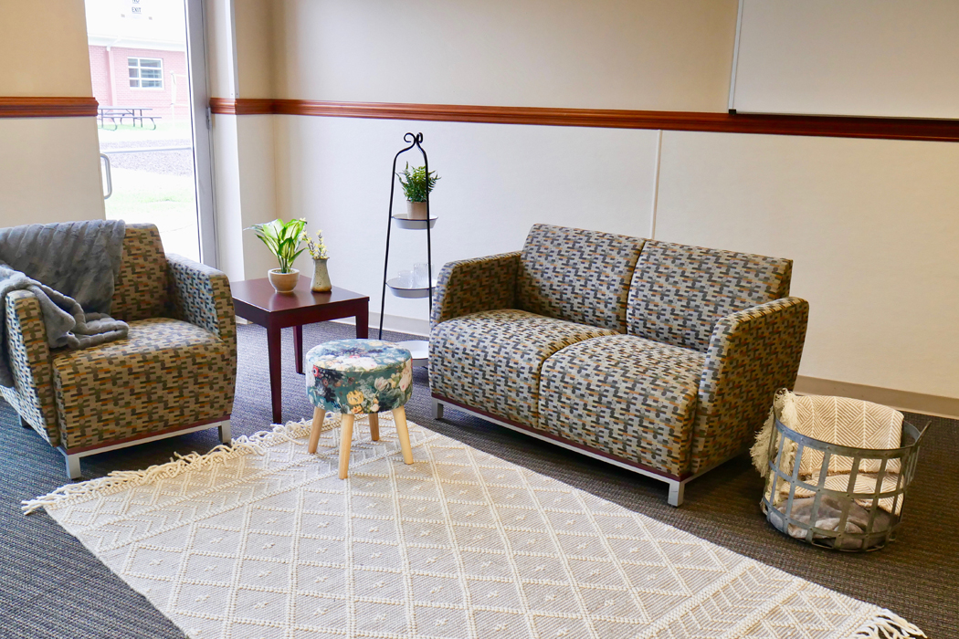 Lounge area with sofa, chairs, and soft lighting
