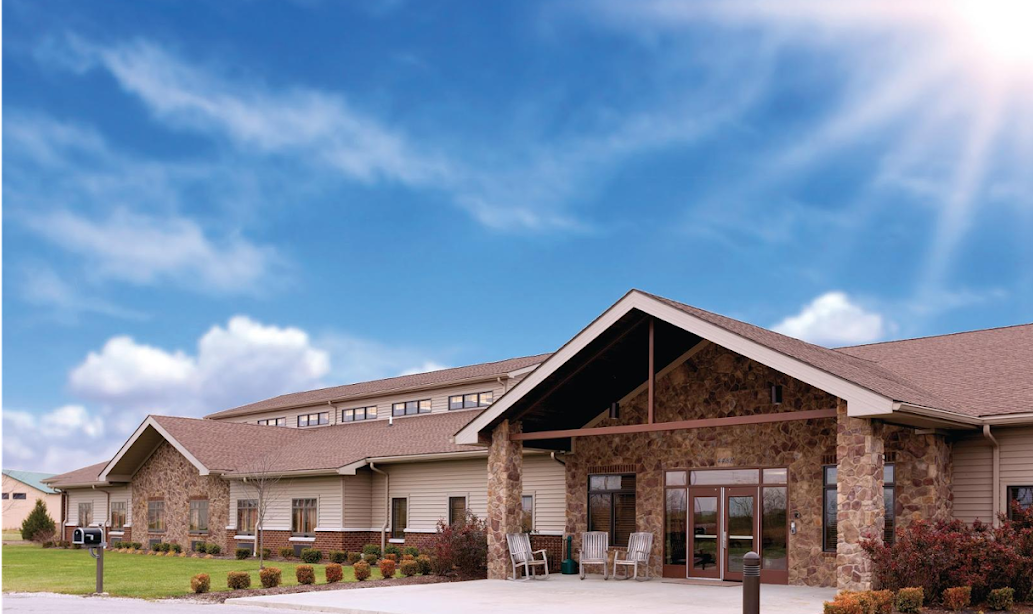 Rehab facility exterior with stone façade under a blue sky