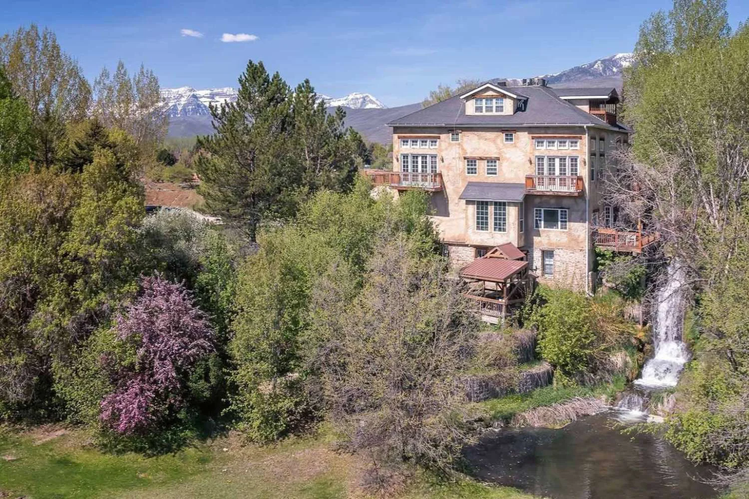 Facility view with waterfall and outdoor lounge.
