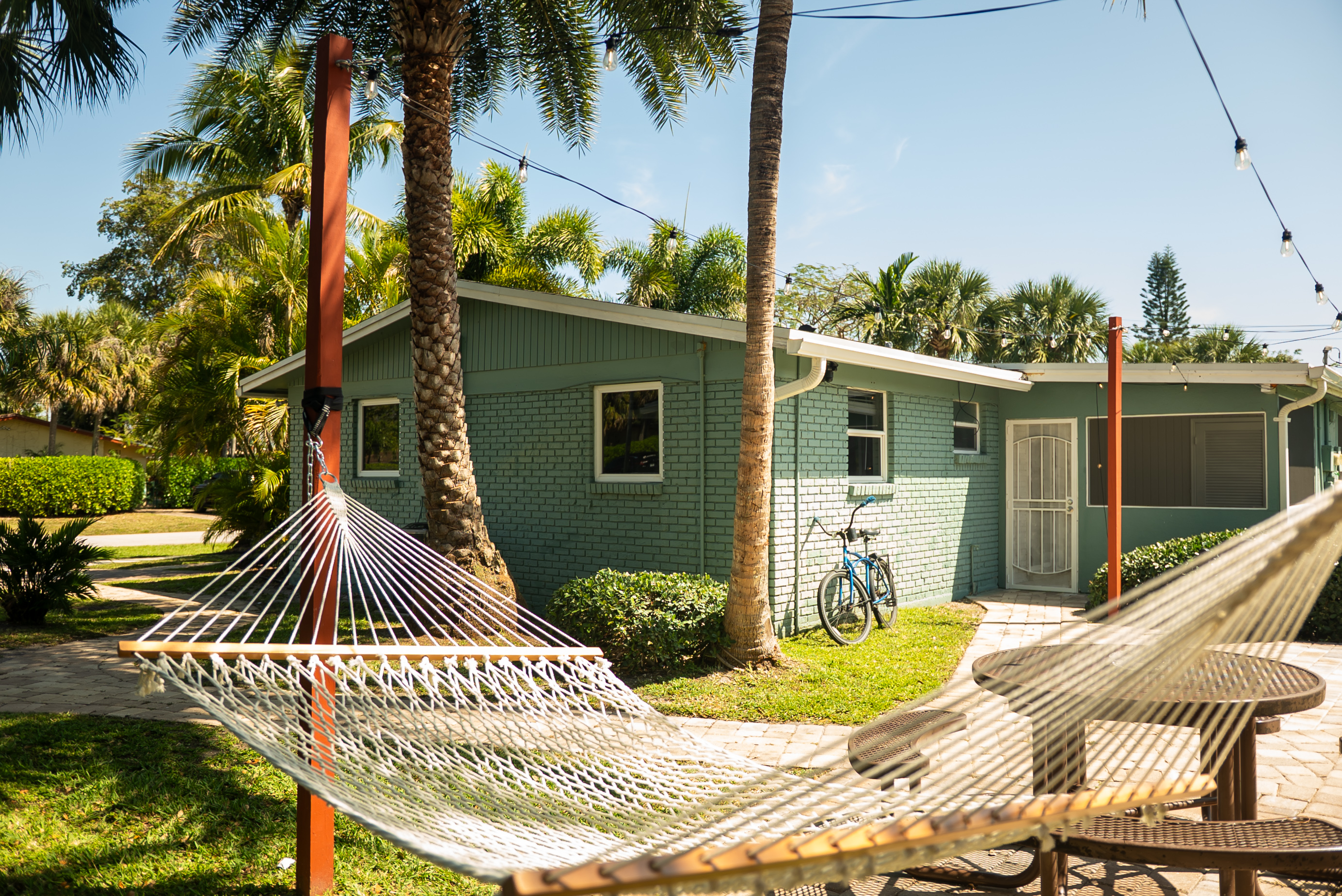 Hammock in backyard with a garden